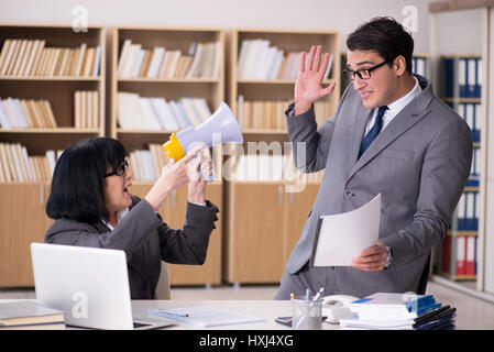 Angry boss reprimanding subordinate employee Stock Photo