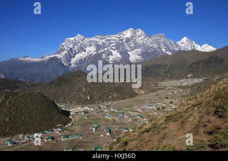Sherpa village Khumjung and high mountains. Spring scene in the Everest National Park, Nepal. Stock Photo