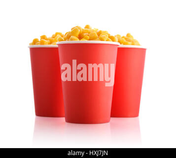 Boiled corn kernels in red paper cups isolated on white Stock Photo