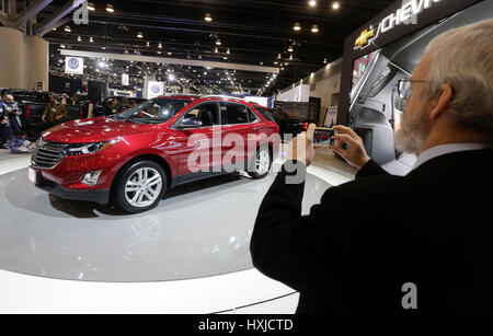 Vancouver, Canada. 28th Mar, 2017. A man shoots a 2017 Chevrolet Equinox SUV at the 97th Vancouver International Auto Show in Vancouver, Canada, on March 28, 2017. The Vancouver International Auto Show is one of the largest of its kind in Canada. Credit: Liang Sen/Xinhua/Alamy Live News Stock Photo