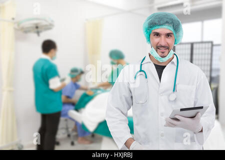 Doctor using digital tablet in operating room Stock Photo