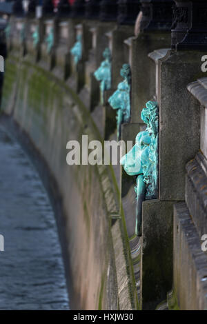 Decorative mooring rings in the shape of lions head along the embankment of the River Thames, London, England, United Kingdom. Act as flood markers. Stock Photo