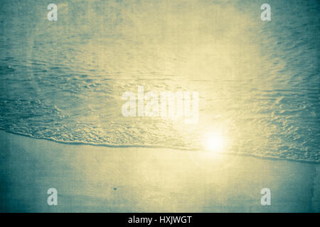 Vintage textured Beach nature backdrop with ocean water, sand and sun flare