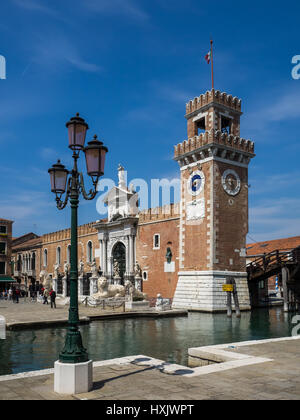 Venetian Naval Arsenal entrance gates with clock tower and canal, Venice, Italy Stock Photo