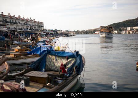 Izmir, Turkey - March 26, 2017: Phokaia port, fisher boats and crowded people on the scene. Stock Photo