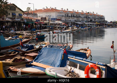 Izmir, Turkey - March 26, 2017: Phokaia port, fisher boats and crowded people on the scene. Stock Photo