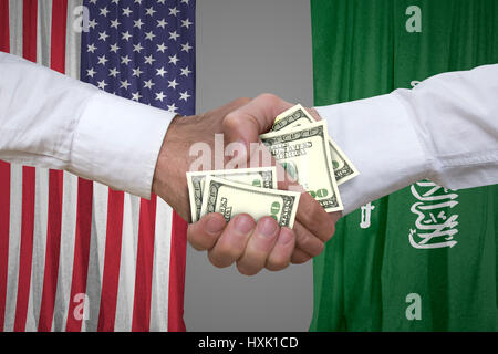 100 dollar bills handshake with USA and Saudi Arabian flags background. Stock Photo