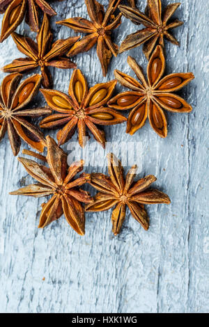 Old, wooden background and star anise seeds Stock Photo