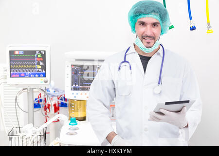 Doctor using tablet computer in operating room Stock Photo