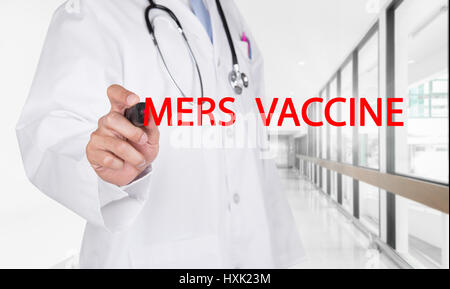 Doctor writing Stop Mers-Cov text on transparent board at new empty hospital hallway background Stock Photo