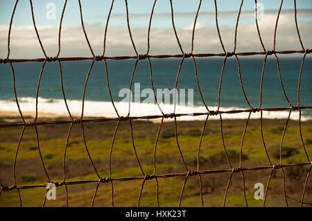 Pattern Steel Fence with a background of the Pacific Ocean Stock Photo