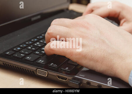 businessman hand using keyboard on computer laptop Stock Photo
