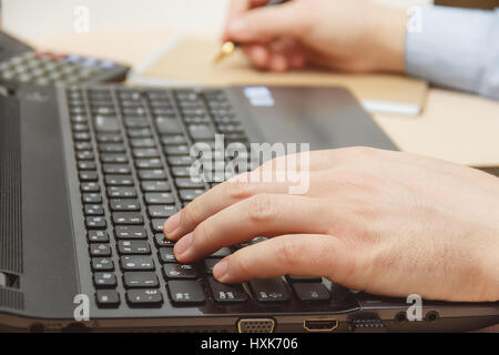 businessman hand using keyboard on computer laptop Stock Photo