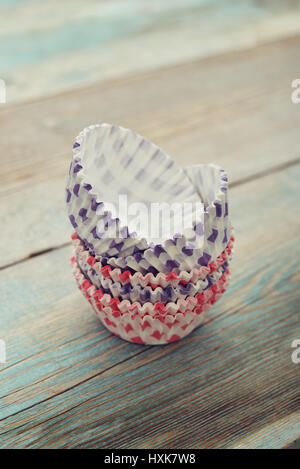 Paper cupcake cases on wooden background Stock Photo