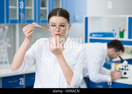 portrait of concentrated woman scientist working in lab Stock Photo