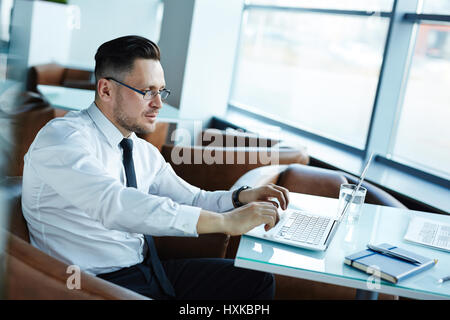 Middle-aged Businessman Working on Laptop Stock Photo
