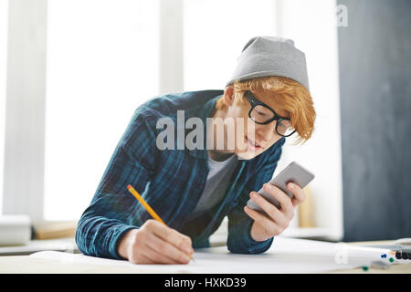Looking for Creative Ideas in Smartphone Stock Photo