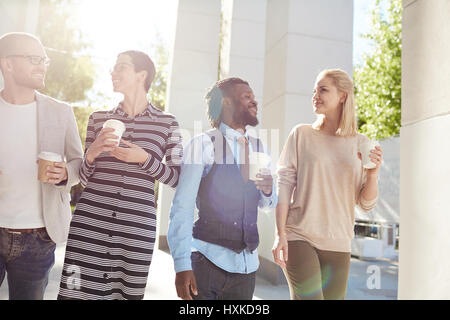 Walking in city center with coworkers Stock Photo
