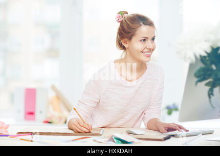 Pretty worker at office desk Stock Photo