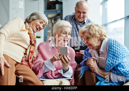 Looking through funny photos Stock Photo