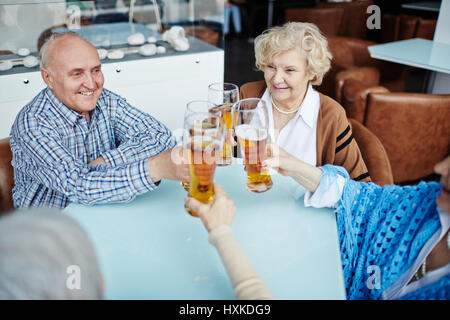 Senior people gathered in pub Stock Photo