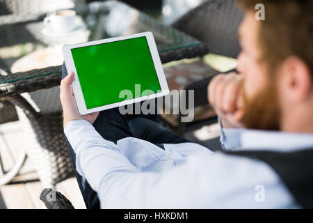 Pensive businessman with digital tablet Stock Photo