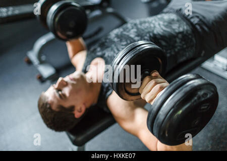 Strong Man Doing Bench Press in Gym Stock Photo