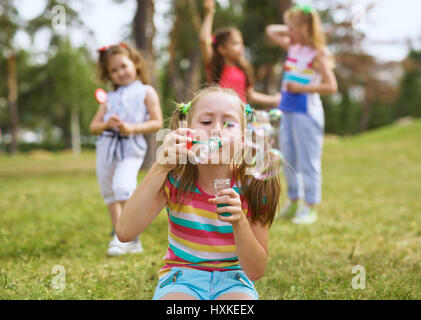 Blowing bubbles in park Stock Photo