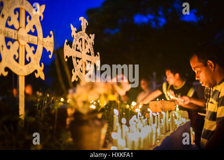 Pilgrims praying at the Cathedral Cemetery as a part of Semana Santa (Holy Week celebration) in Larantuka, Indonesia. Stock Photo