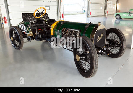 A  1909 Berliet Curtiss  race car. in the international paddock pit garages, during the Silverstone Classic Media Day Stock Photo