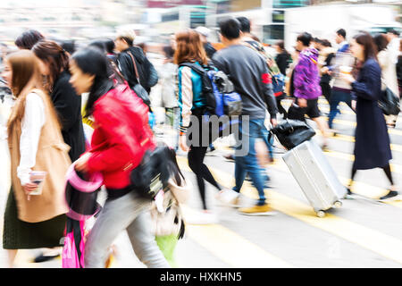 picture made with motion blur of people crossing a street in Hongkong ...