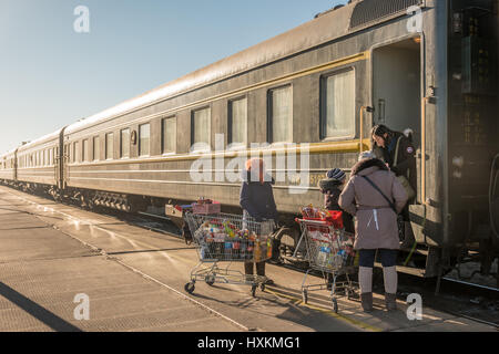 Mongolian women selling snacks to the passengers on the Trans-Mongolian Train from Beijing, China, to Ulaanbaatar, Mongolia. Stock Photo