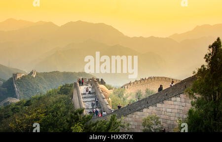 BEIJING, CHINA - SEPTEMBER 29, 2016: Tourists walking on the Great wall of China at sunset time Stock Photo