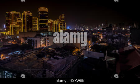 High Sky bar view of the contrasts of night time cityscape of Metro Manila, Philippines. Stock Photo