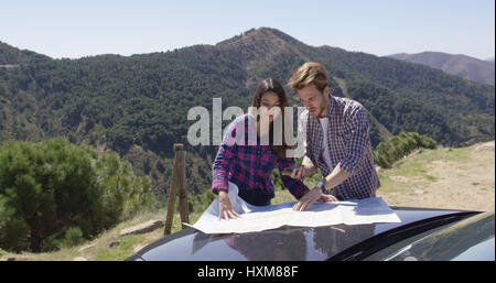 Two people looking at map searching route Stock Photo