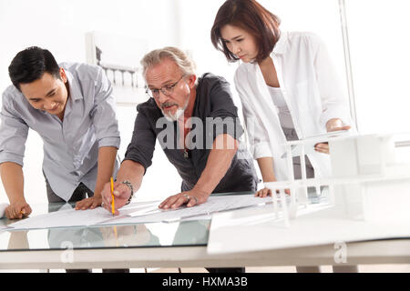 Architects working on blueprint Stock Photo