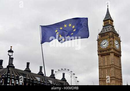 An EU flag flies in front of the Houses of Parliament in Westminster, London, after the letter informing the European Council of Britain's intention to leave the European Union has been handed over to EC president Donald Tusk in Brussels. Stock Photo