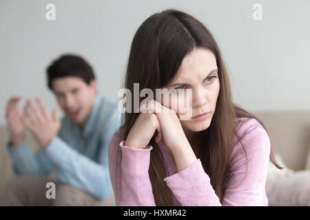 Quarrel between man and woman. Guy shouting, frustrated girl ign Stock Photo