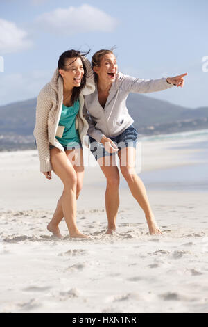 Portrait of two friends laughing and enjoying life at the beach Stock Photo