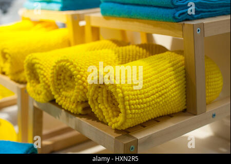 yellow towels on the shelf in the closet Stock Photo