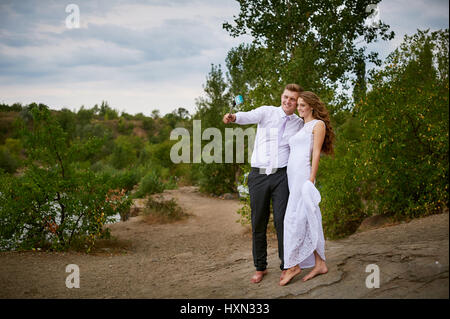 bride and groom on a wedding walk take selfie Stock Photo