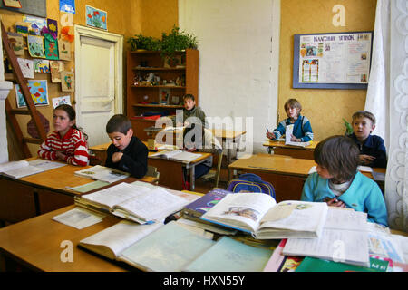 Podol village, Tver region, Russia - May 5, 2006: Students are sitting at their desks in a classroom during a lesson, elementary rural school. Stock Photo