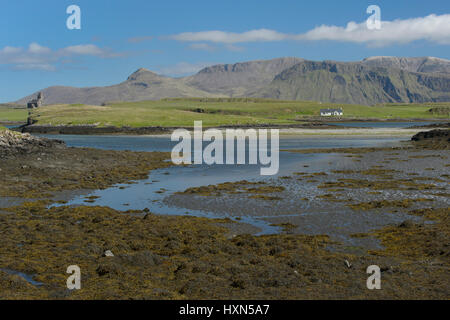 View across Canna harbour to isle of Sanday and Rum. Small Isles, Scotland. June.