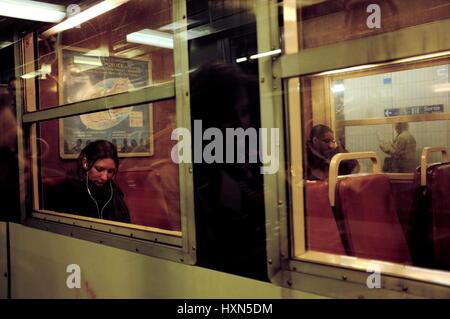 AJAXNETPHOTO. PARIS, FRANCE. - TRAVEL BY TRAIN - PASSENGERS ON A SUBURBAN TRAIN AT NIGHT.  PHOTO:JONATHAN EASTLAND/AJAX REF;FX112703 5279 Stock Photo