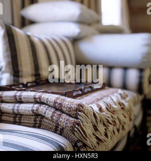 Blanket and tray on striped sofa. Stock Photo
