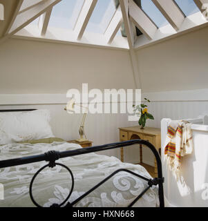 Metal framed bed in attic conversion Stock Photo