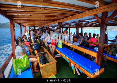 Antalya, Turkey - 28 august, 2014: Many passengers sitting aboard tourist yacht, during the excursion trip in the Mediterranean Sea.
