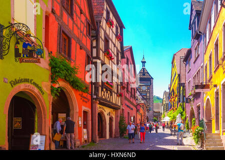 Riquewihr, France-June 23, 2016: Tourists are walking on the main shopping street; Rue du General de Gaulle, in Riquewihr, Alsace France Stock Photo