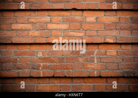 Part of old brick wall lined with steps across five rows of brickwork. Stock Photo