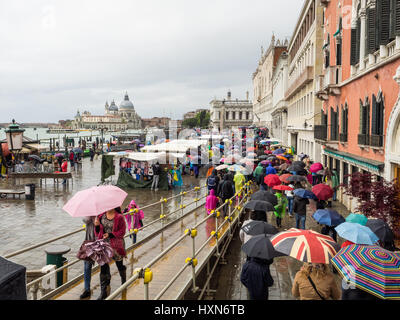 Venice in the rain with tourists carrying umbrellas Stock Photo
